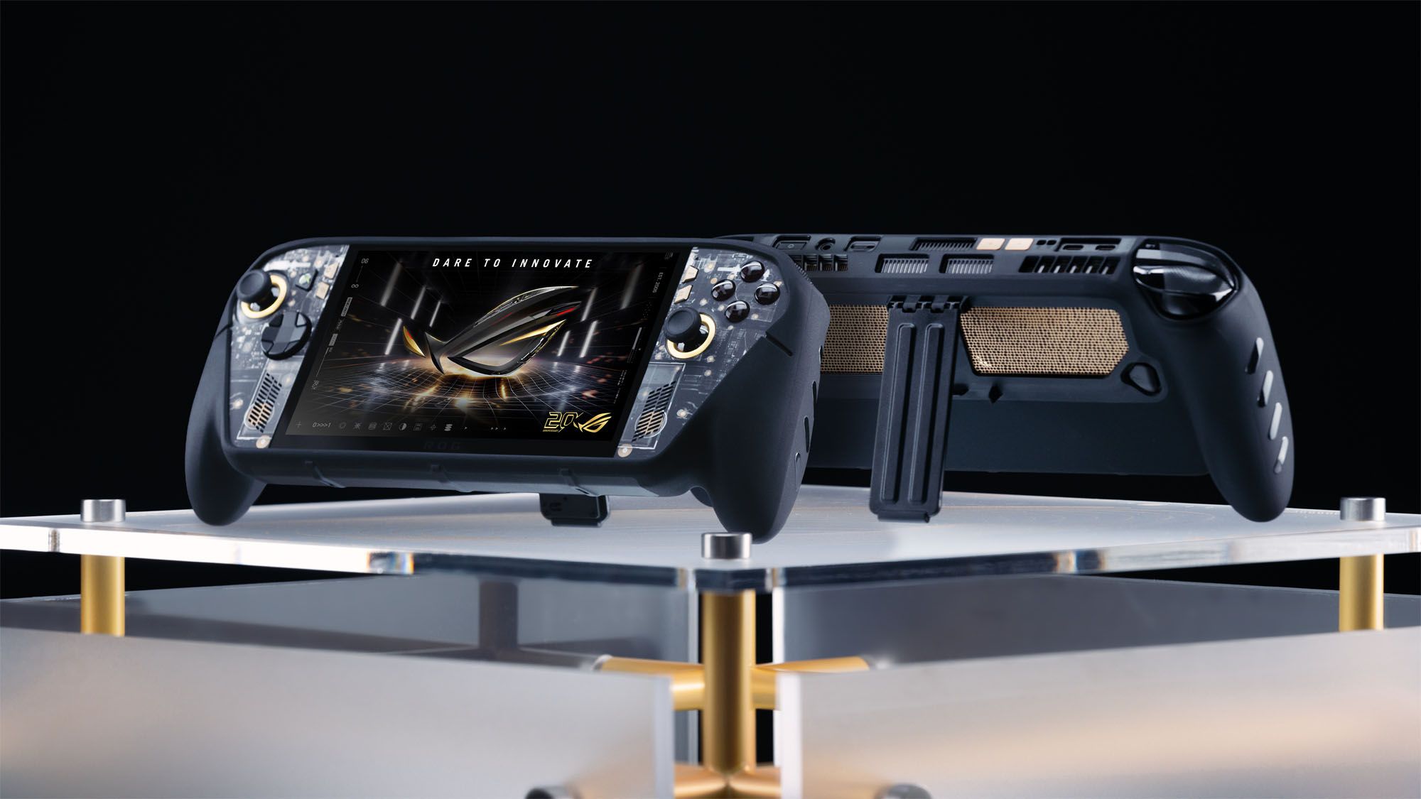جهازان محمولان من طراز ROG XBOX Ally X20 داخل علب dbrand Killswitch موضوعان ظهراً لظهر على طاولة