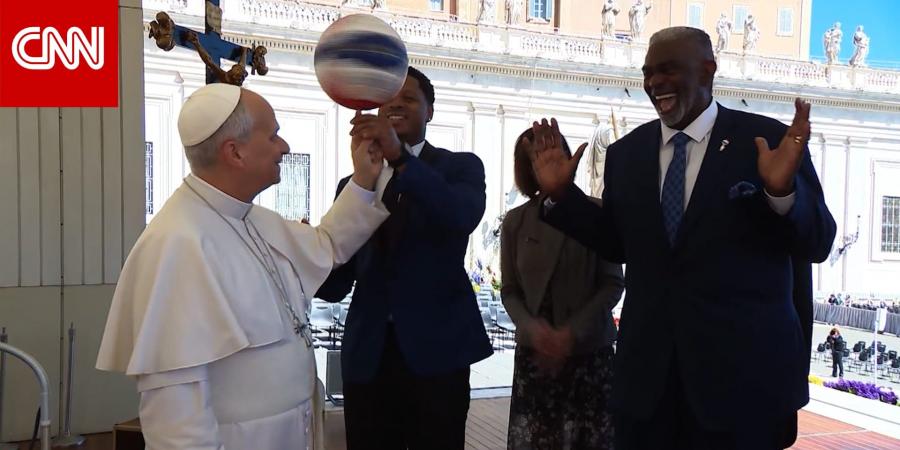 البابا لاوُن يُدير كرة سلة على إصبعه خلال استقبال فريق "هارلم غلوبتروترز" الاستعراضي